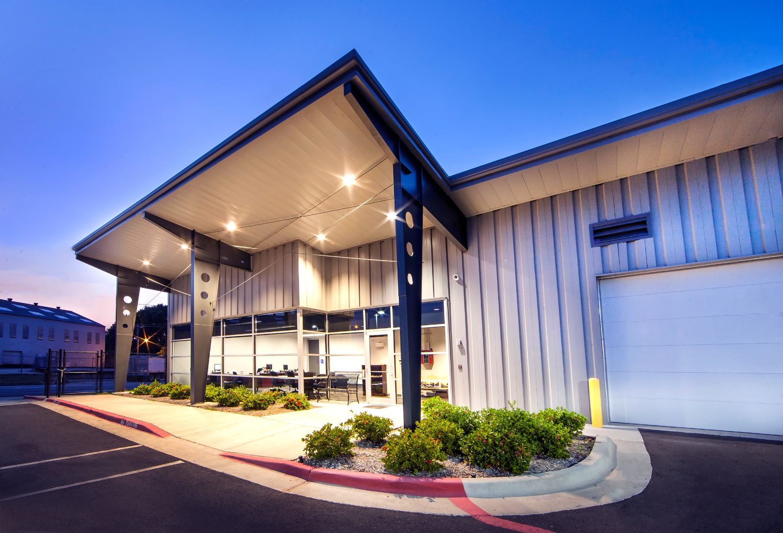 Metal building entry canopy at dusk